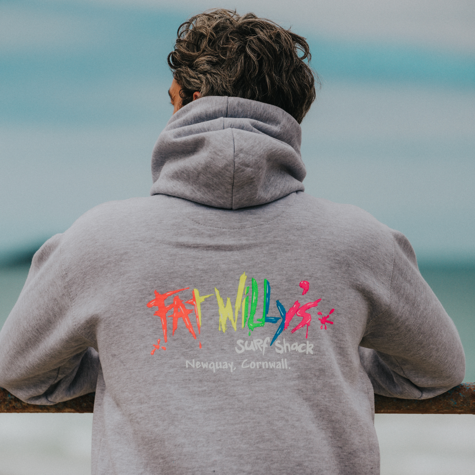 Model wearing sport grey Fat Willy’s hoodie outdoors with retro logo visible
