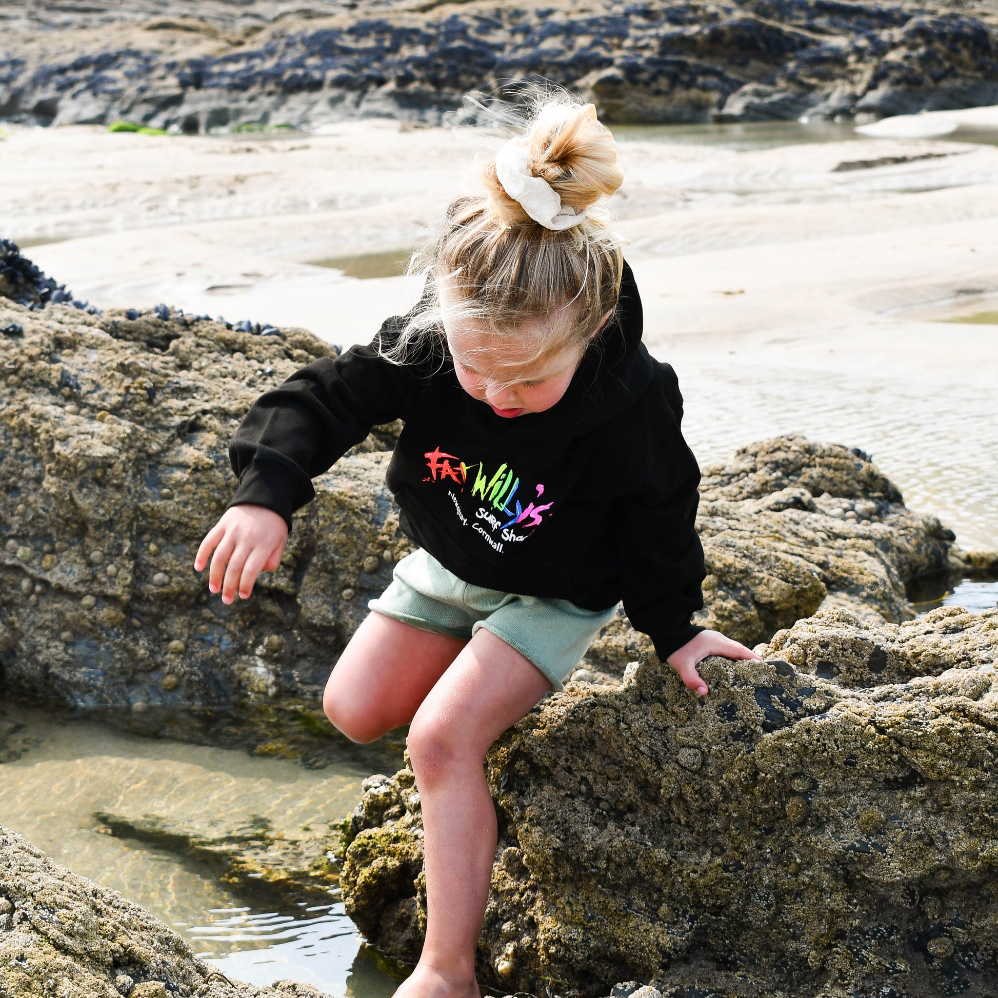 Child playing on rocks at a beach