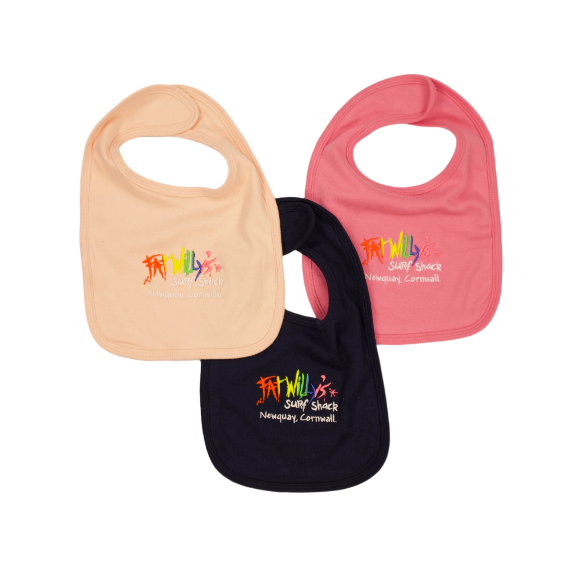 Three baby bibs in beige, pink, and navy with colorful text on a beige background